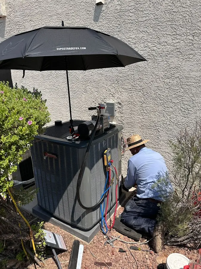 HVAC technician performing outdoor AC maintenance in Monticello